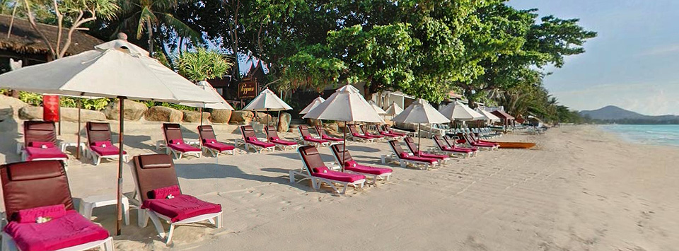 The white sandy beach with Poppies hotel reclining chairs on