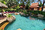 Rock lined swimming pool with loungers